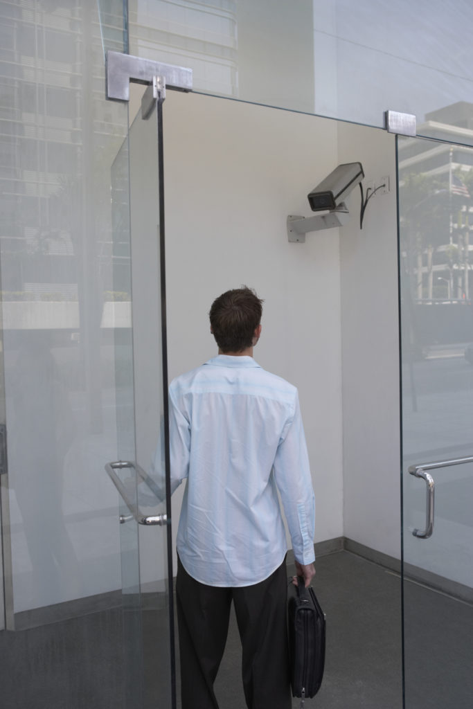 Rear view of a young man standing in a doorway